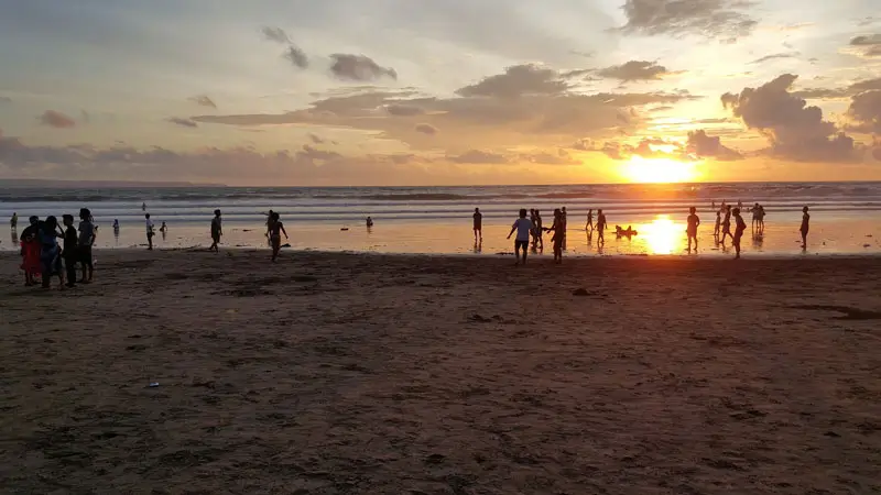 Sunset di Pantai Kuta Bali dengan wisatawan menikmati sore hari